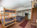 Bedroom with queen bed and twin bunk beds